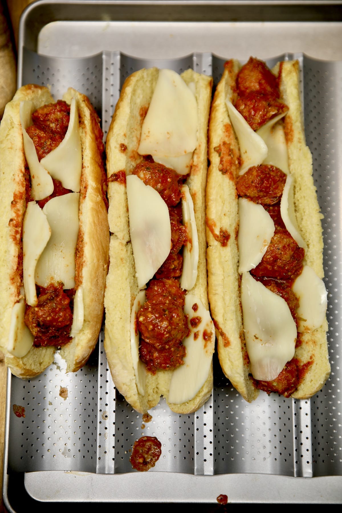 Meatball sub sandwiches with fresh mozzarella cheese.