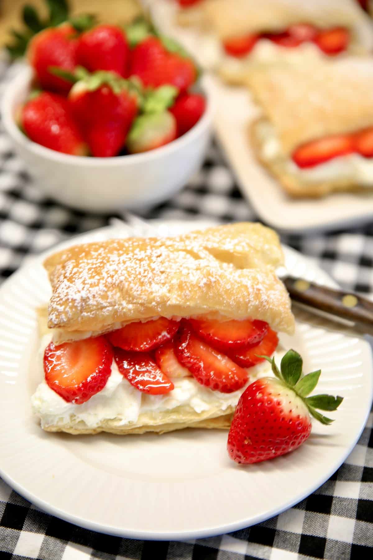 Strawberry puff pastry dessert on a plate.