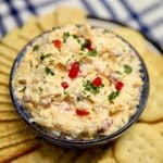 Bowl of pimento cheese with crackers.