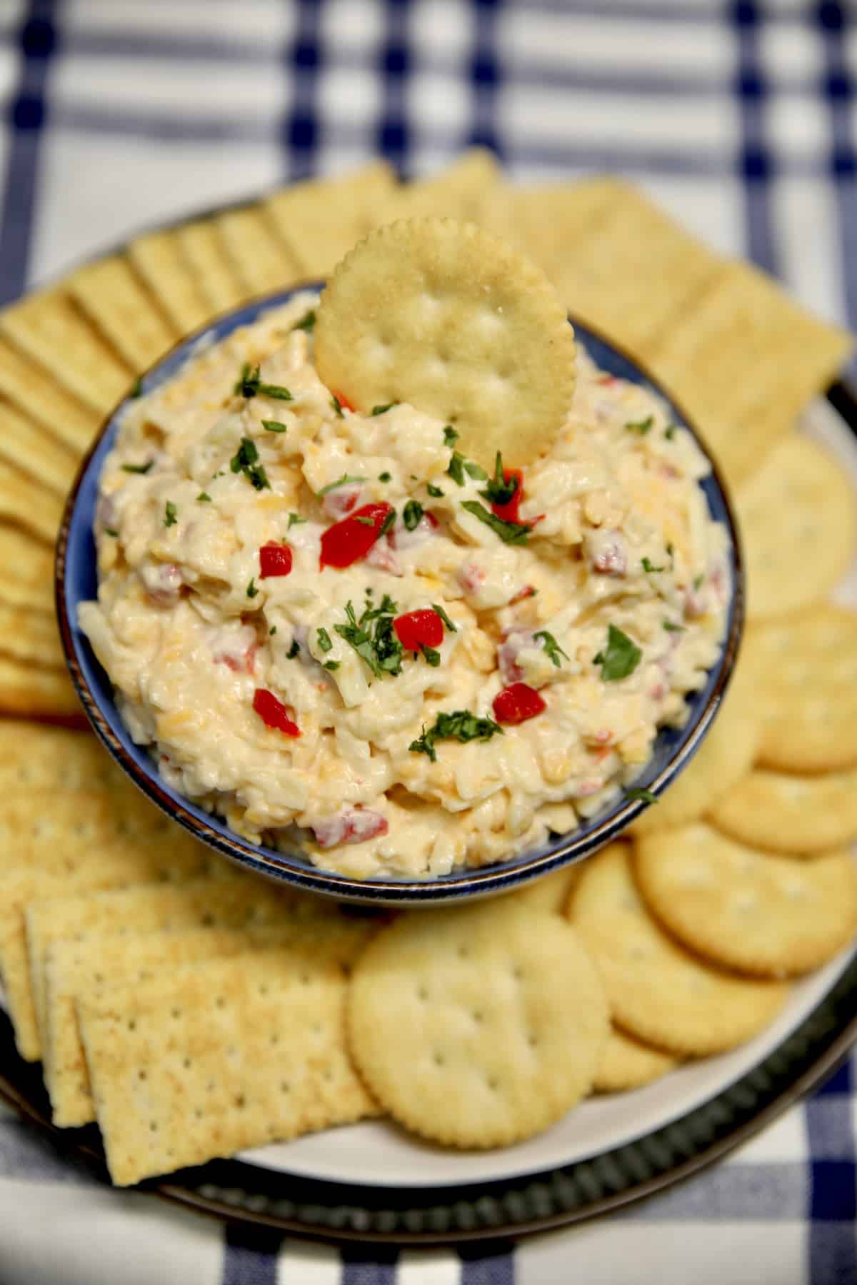 Bowl of pimento cheese with a cracker in the top.