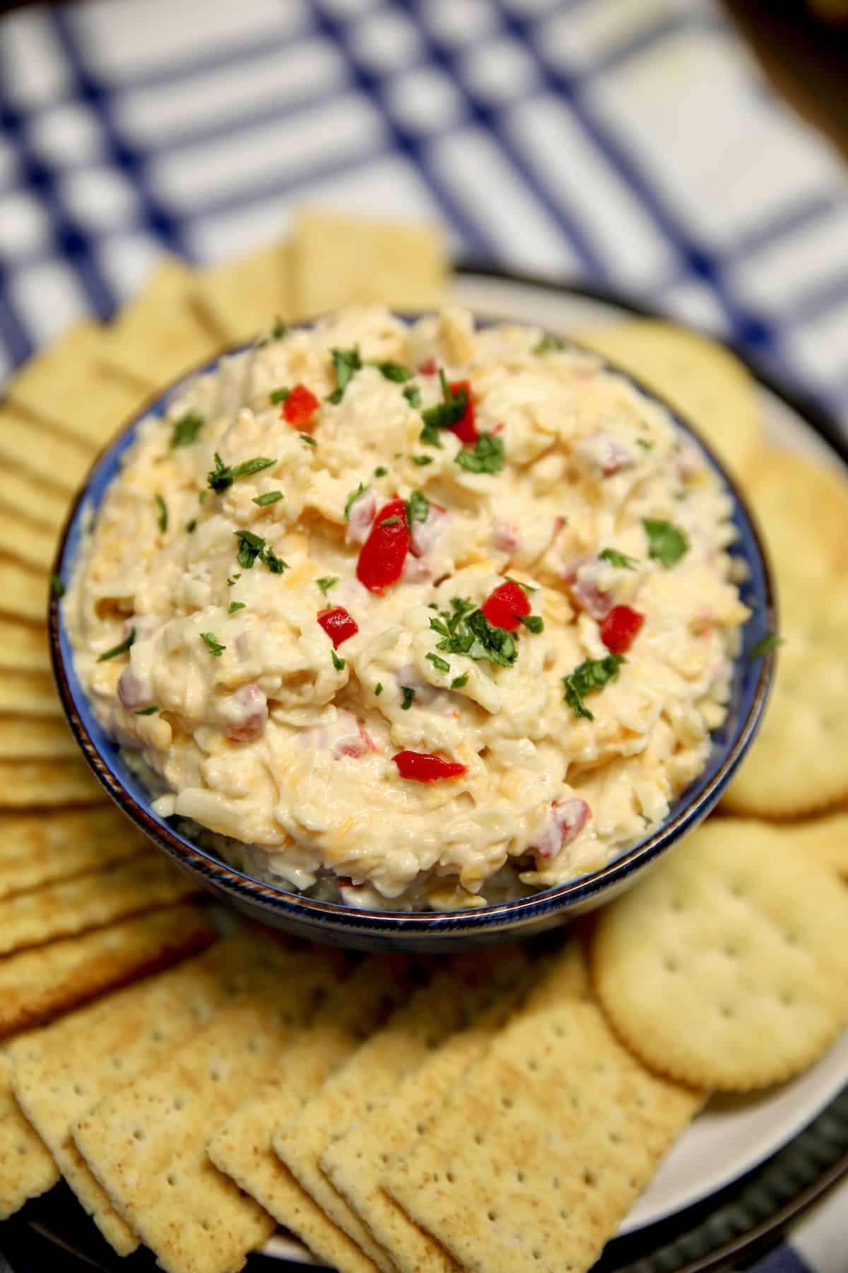 Bowl of pimento cheese dip with crackers.