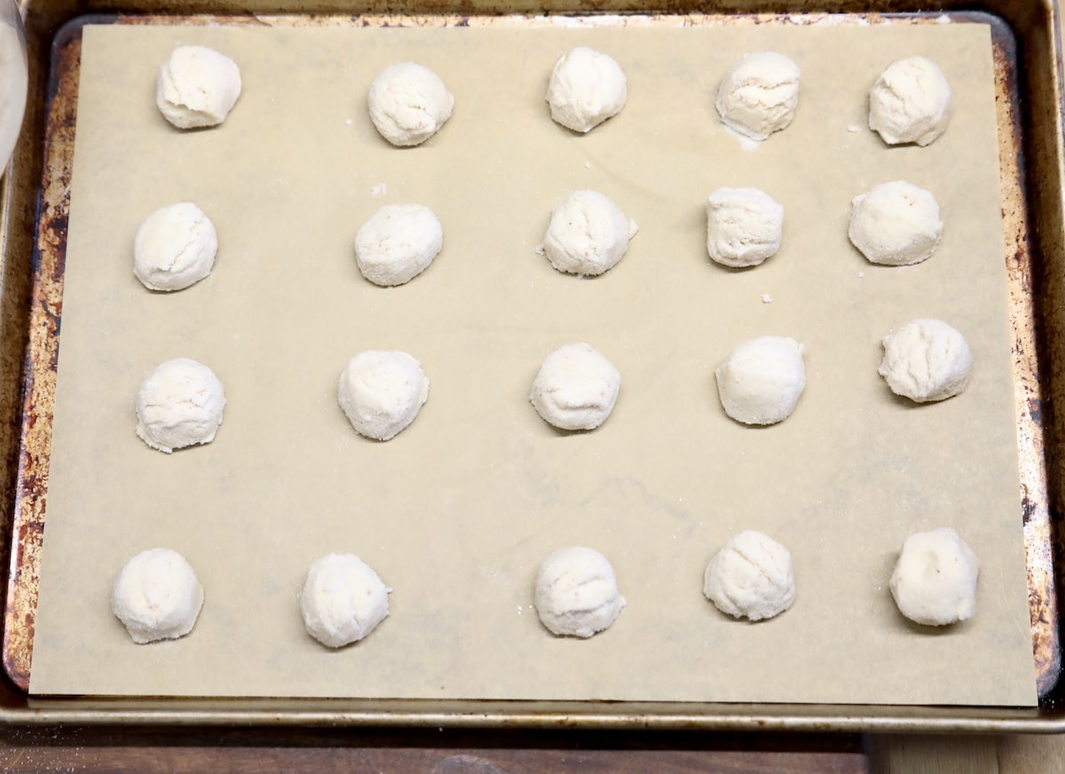 Cookie balls on a sheet pan.