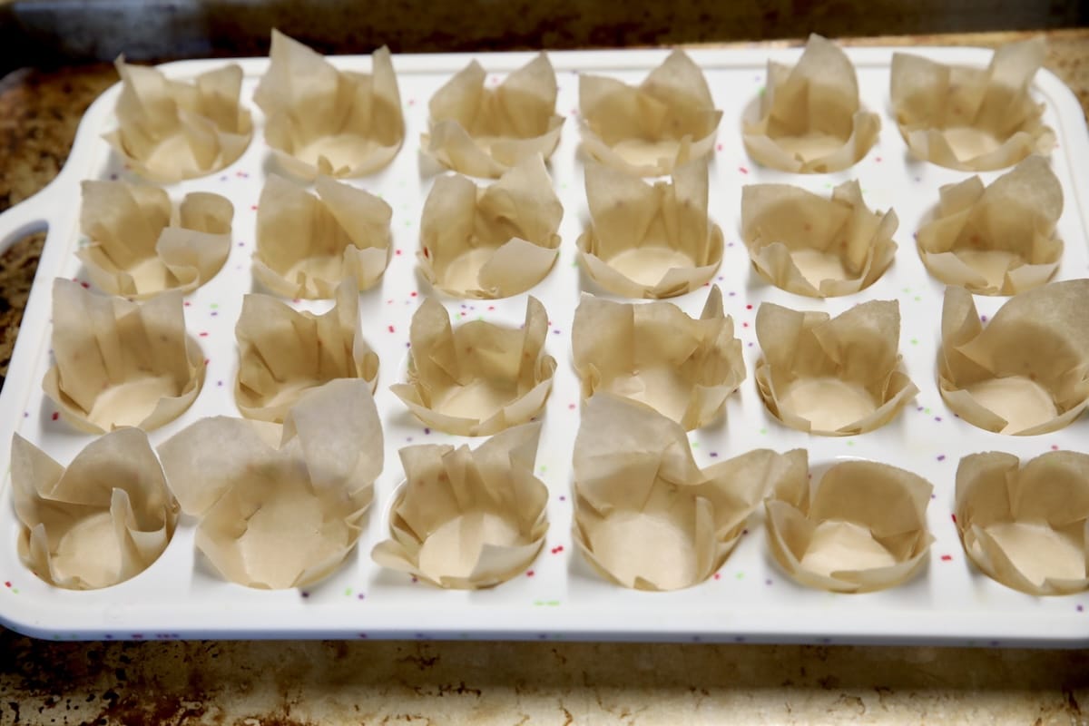 Mini cupcake pan with parchment liners.