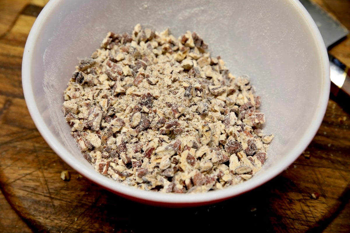 Pecans with flour in a bowl.