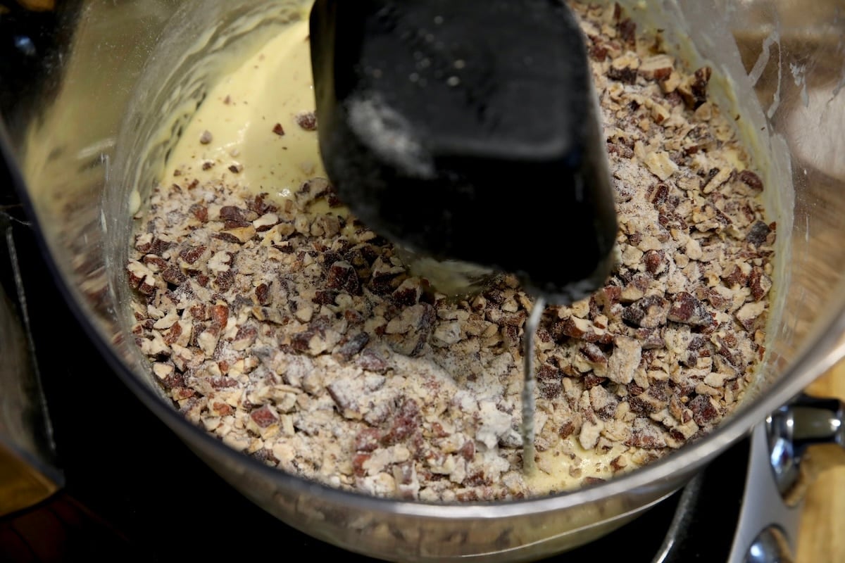 Bowl of cake batter with chopped pecans.