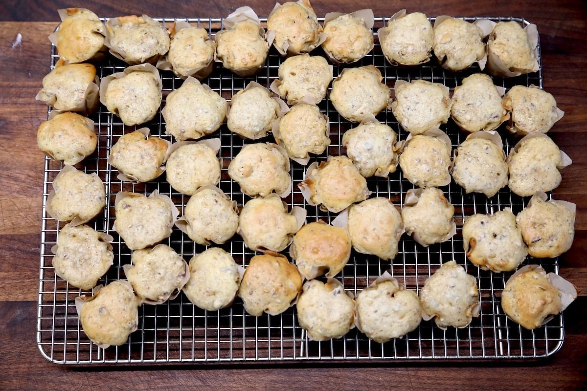Mini cupcakes on a wire rack.