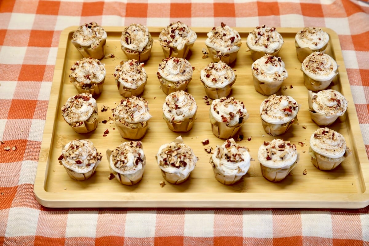 Platter of mini cupcakes with pecan cream cheese icing.
