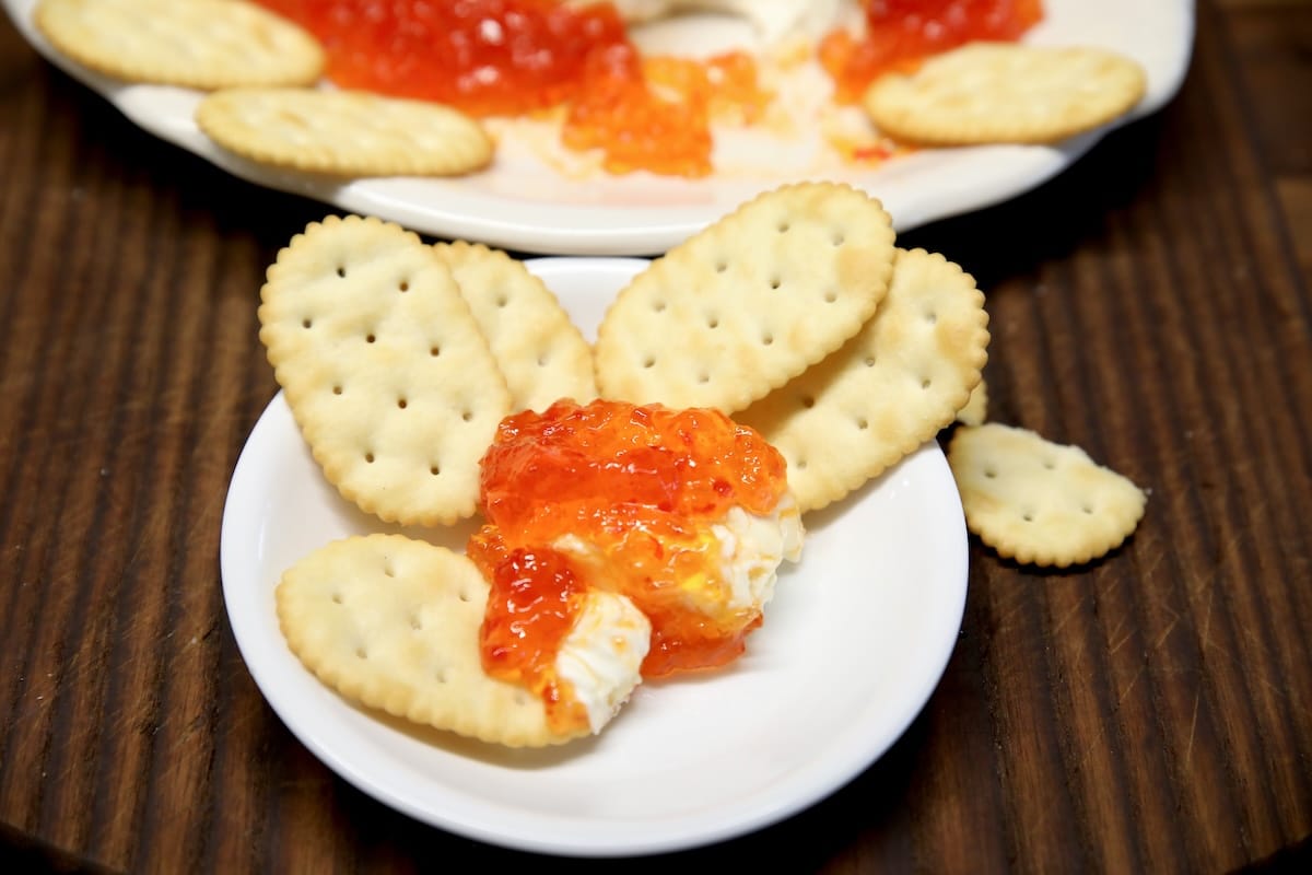 Crackers with cream cheese pepper jelly dip.
