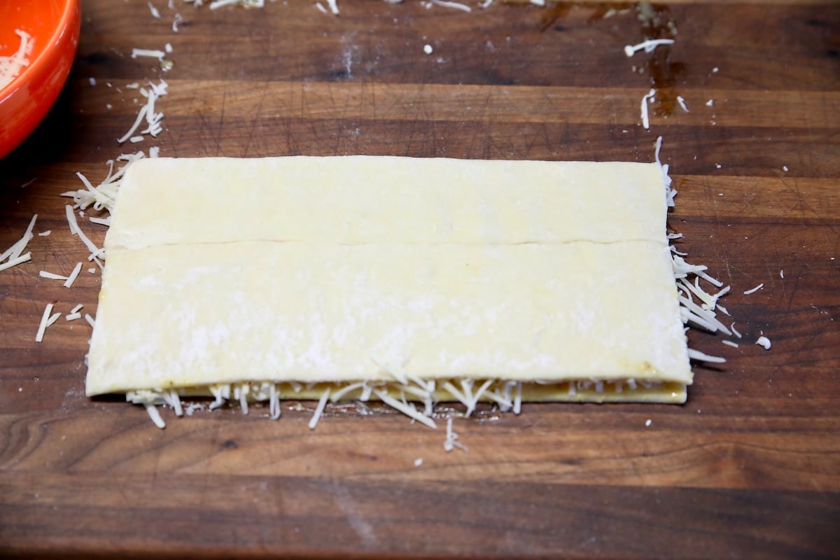 Puff pastry filled with cheese folded in half.