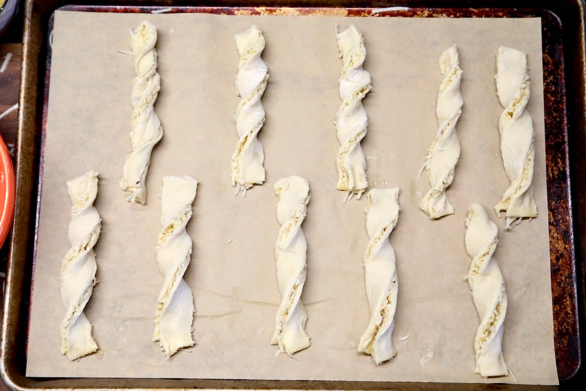 Puff pastry twists on a baking sheet.