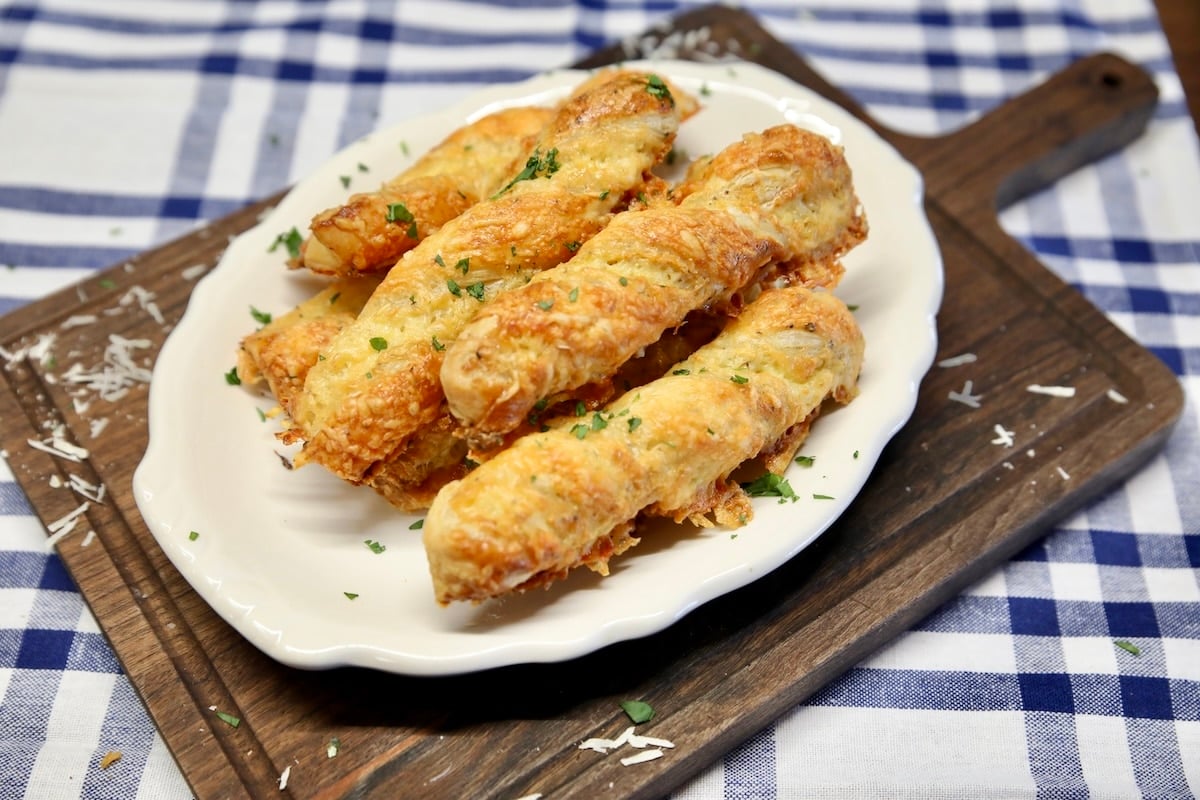 Cheese straws made with puff pastry. Platter of puff pastry twists.