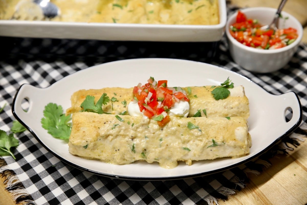 Platter of turkey enchiladas with salsa verde sauce. Platter of turkey enchiladas with sour cream and pico de gallo.