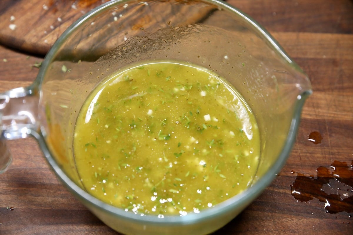 Brine for pickled shrimp in a glass measure.