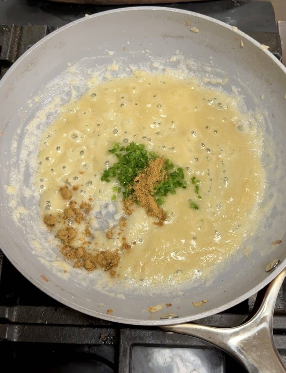 Jalapeno and cumin in a pan.