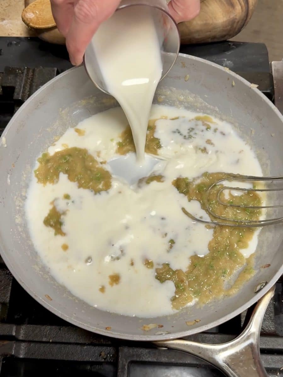Adding milk to skillet for sauce.