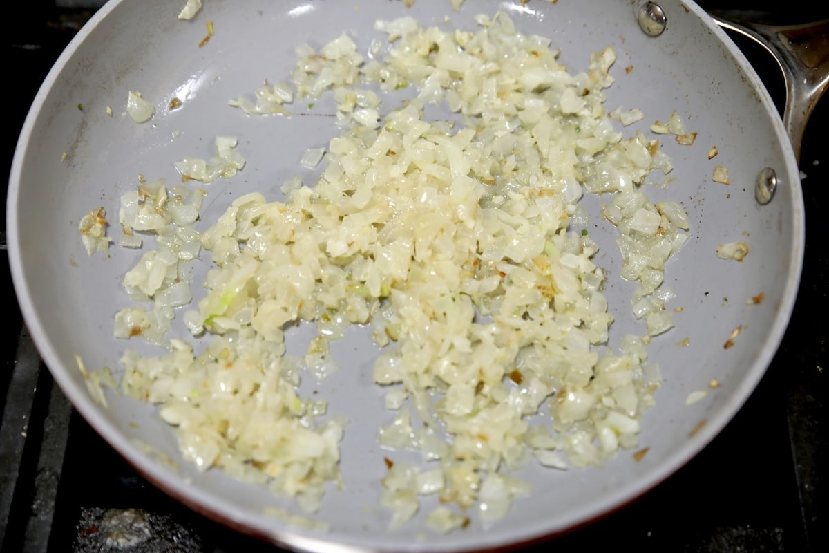 Saut&eacute;ed onion and garlic in a pan.