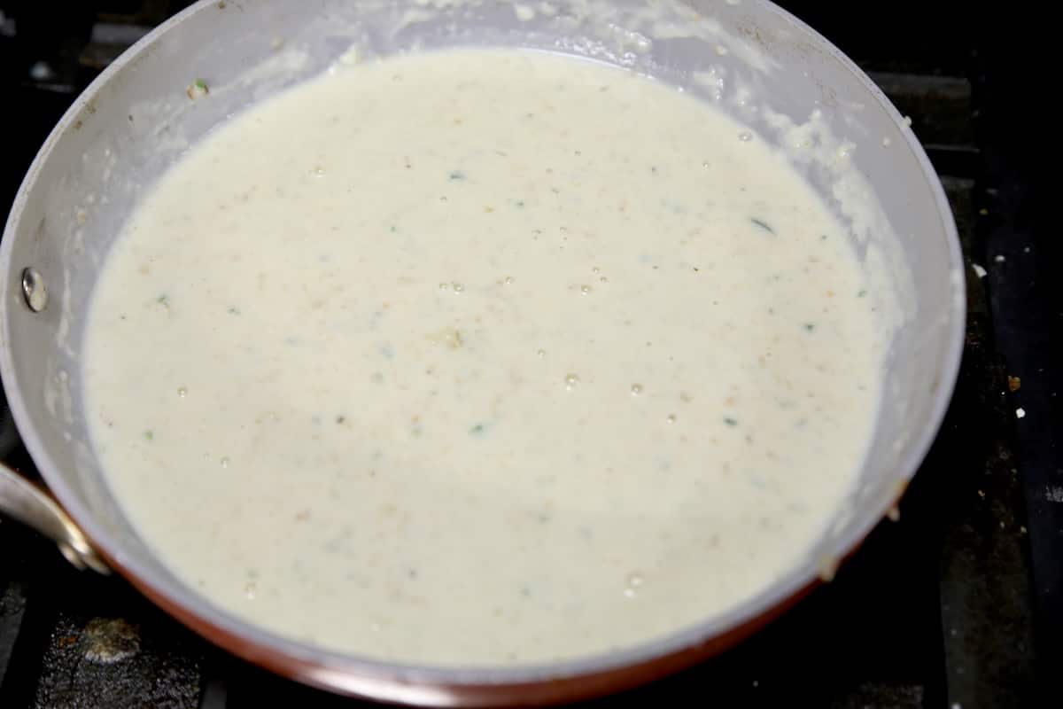 Creamy enchilada sauce in a pan.