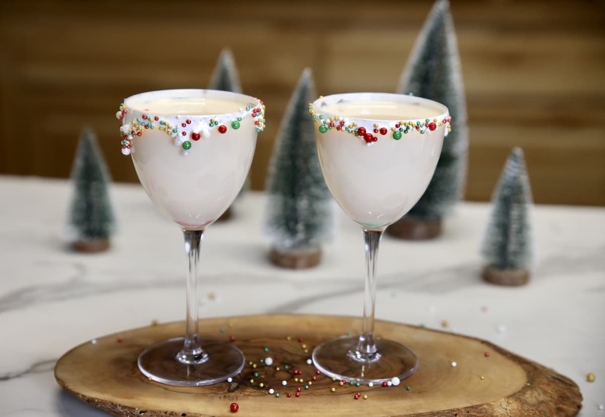 Creamy vodka cocktail with amaretto and Irish cream. Sugar Cookie cocktail in 2 coupe glasses- sprinkled rim.