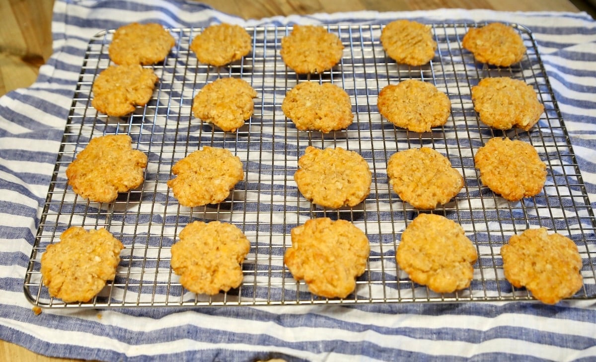 Cheese wafers cooling on wire rack.