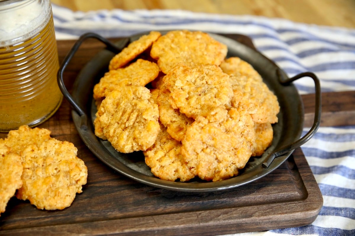 Cheese Wafers with Rice Krispies and sharp cheddar. Plate of cheese wafers on a cutting board.