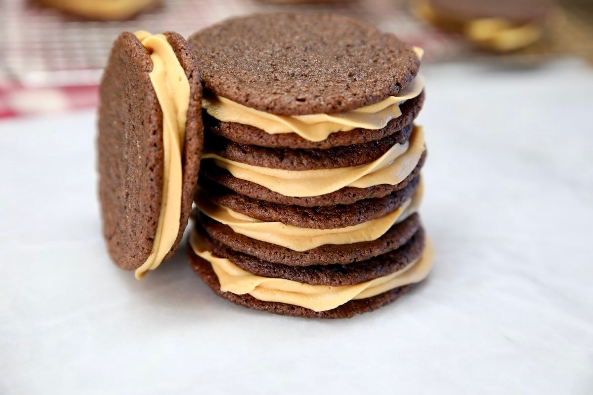Stack of chocolate caramel sandwich cookies.