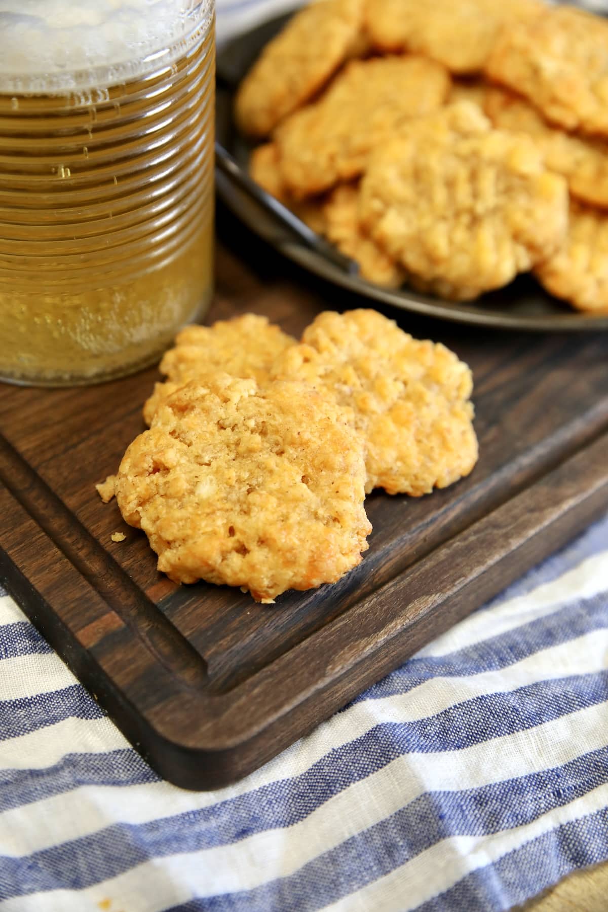 Cheesy Rice Krispie wafers. Cheese wafers on a cutting board with beer