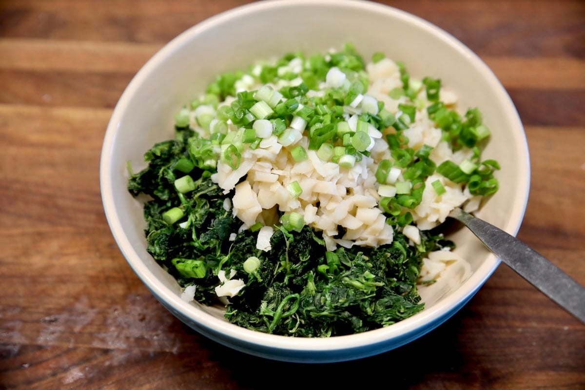 Bowl of spinach dip with ranch dressing mix ingredients.