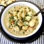 Bowl of seafood chowder with oyster crackers.