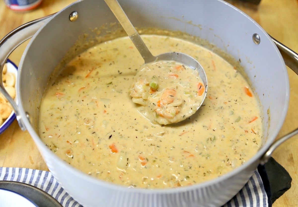 Seafood chowder in a ladle.