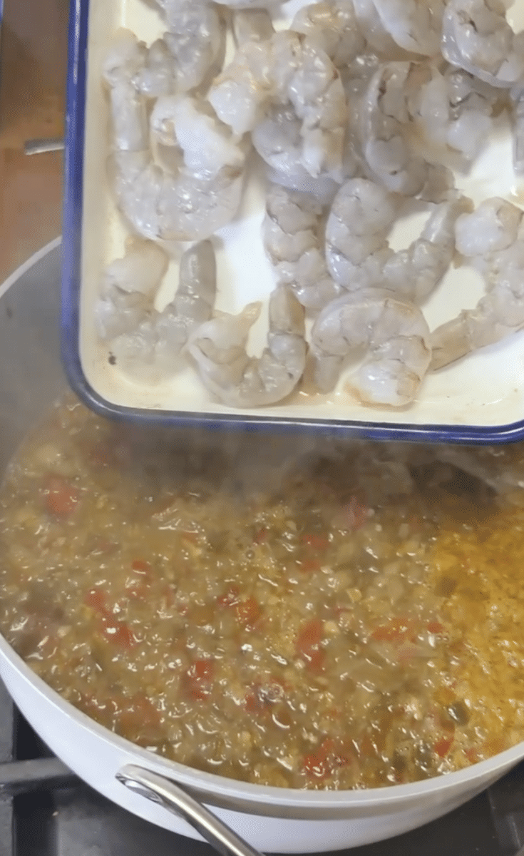 Adding shrimp to soup.