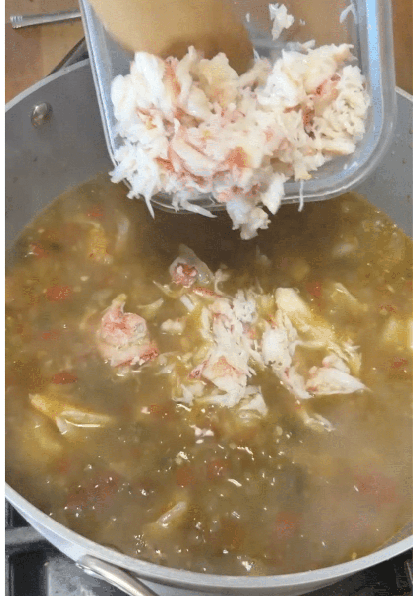 Adding crab meat to soup.