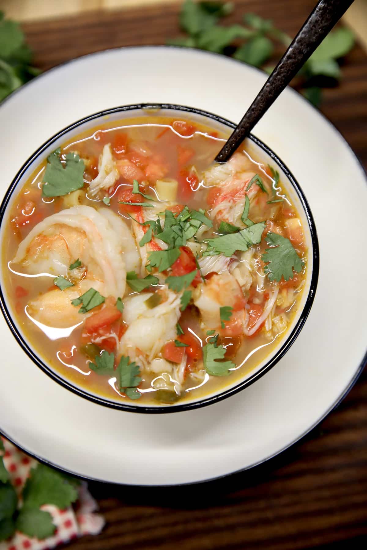 Seafood soup in a bowl with spoon.