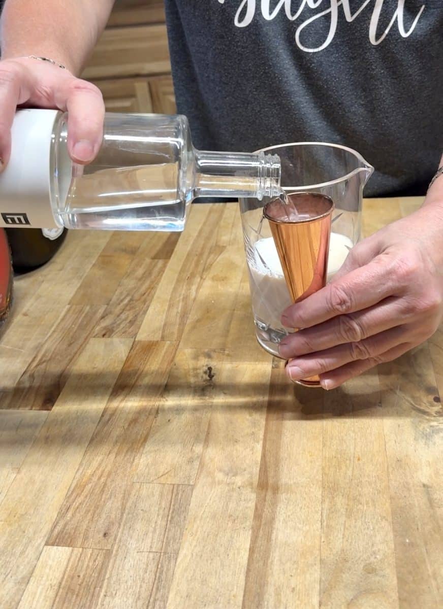 Pouring vodka into a jigger.