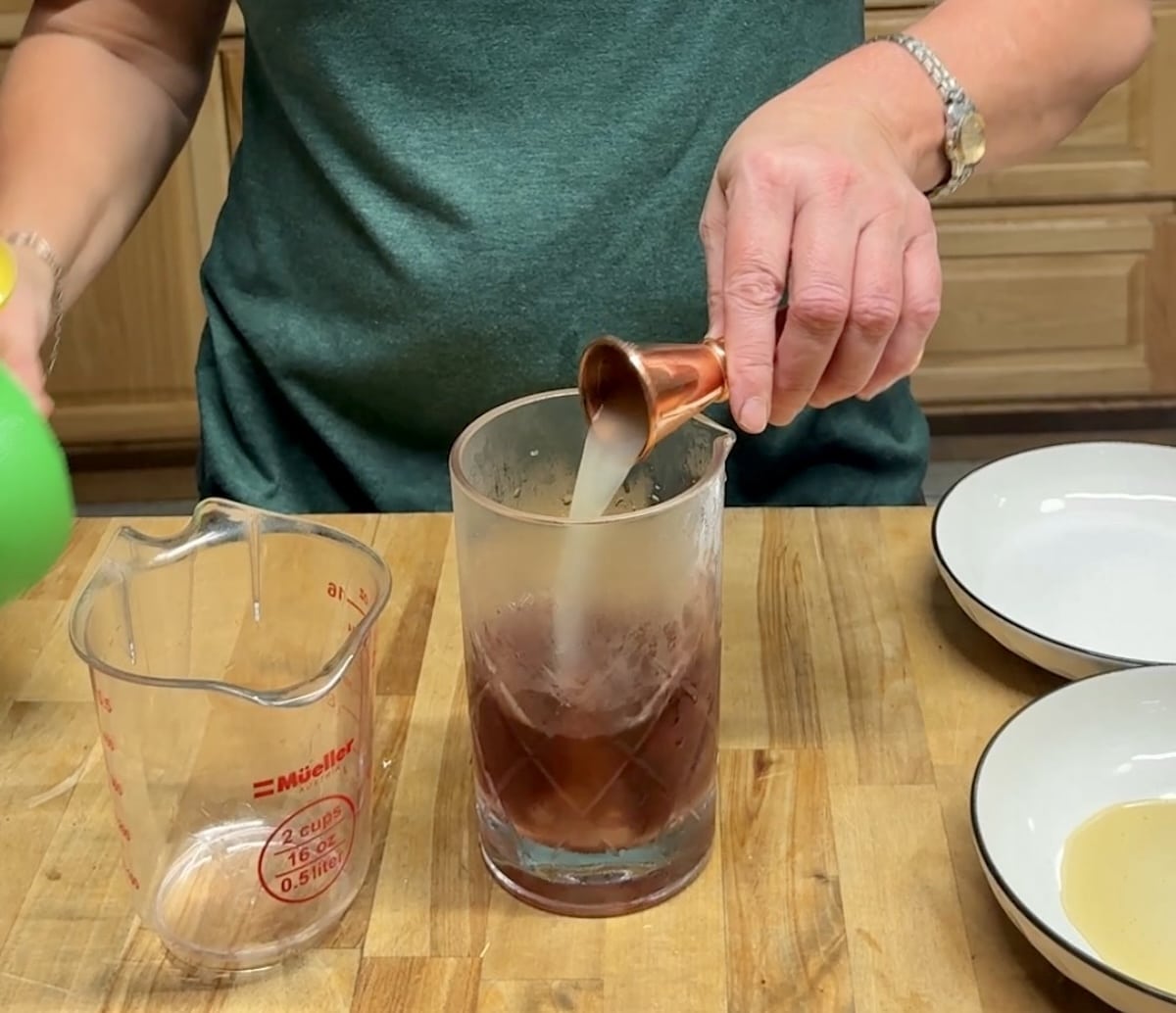 Adding lime juice to mixer glass.