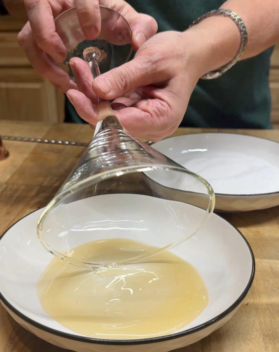 Rolling a glass rim in honey.
