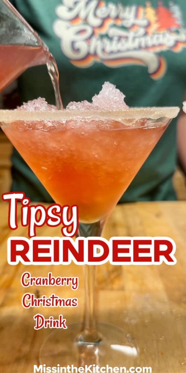 Pouring cranberry vodka cocktail over crushed ice.