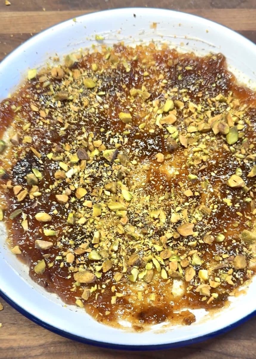 Pistachio, fig and garlic her dip in a pie plate.