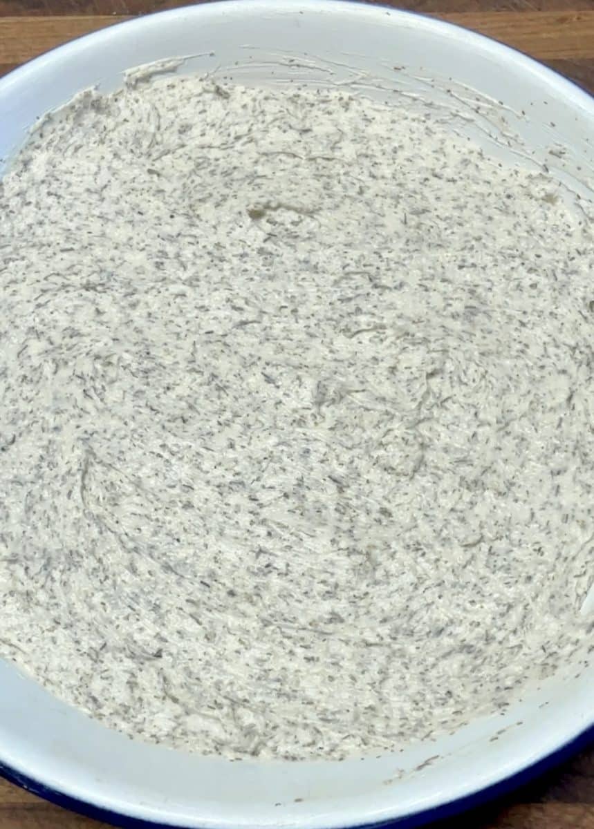 Garlic and herb cheese in a pie dish.