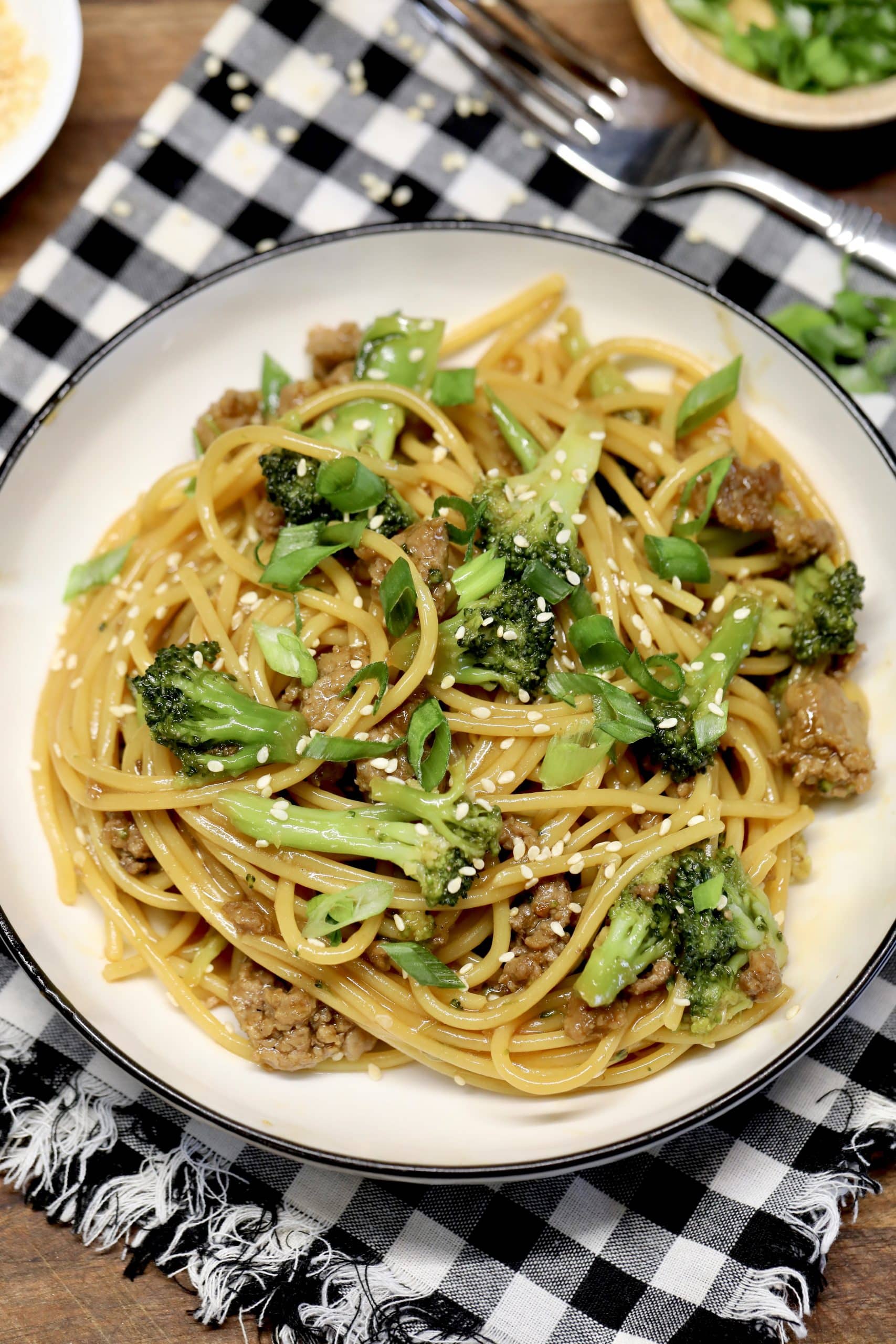 Ground Beef and Broccoli Bowls. Ground beef and broccoli noodles in a bowl with sesame sauce.