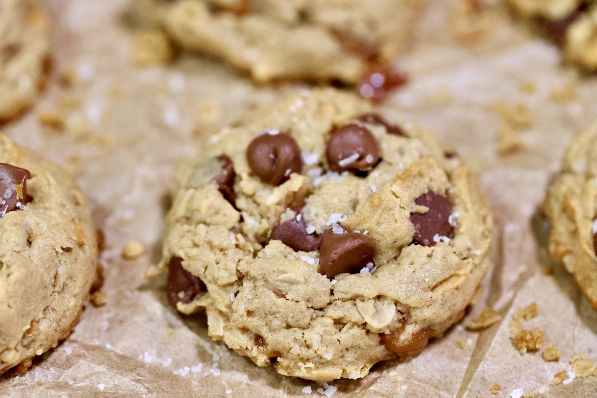 Chocolate chip oatmeal cookies on parchment paper.