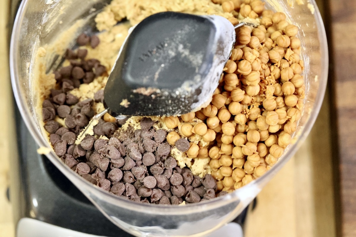 Mixer bowl with cookie dough, chocolate chips, caramel bits.