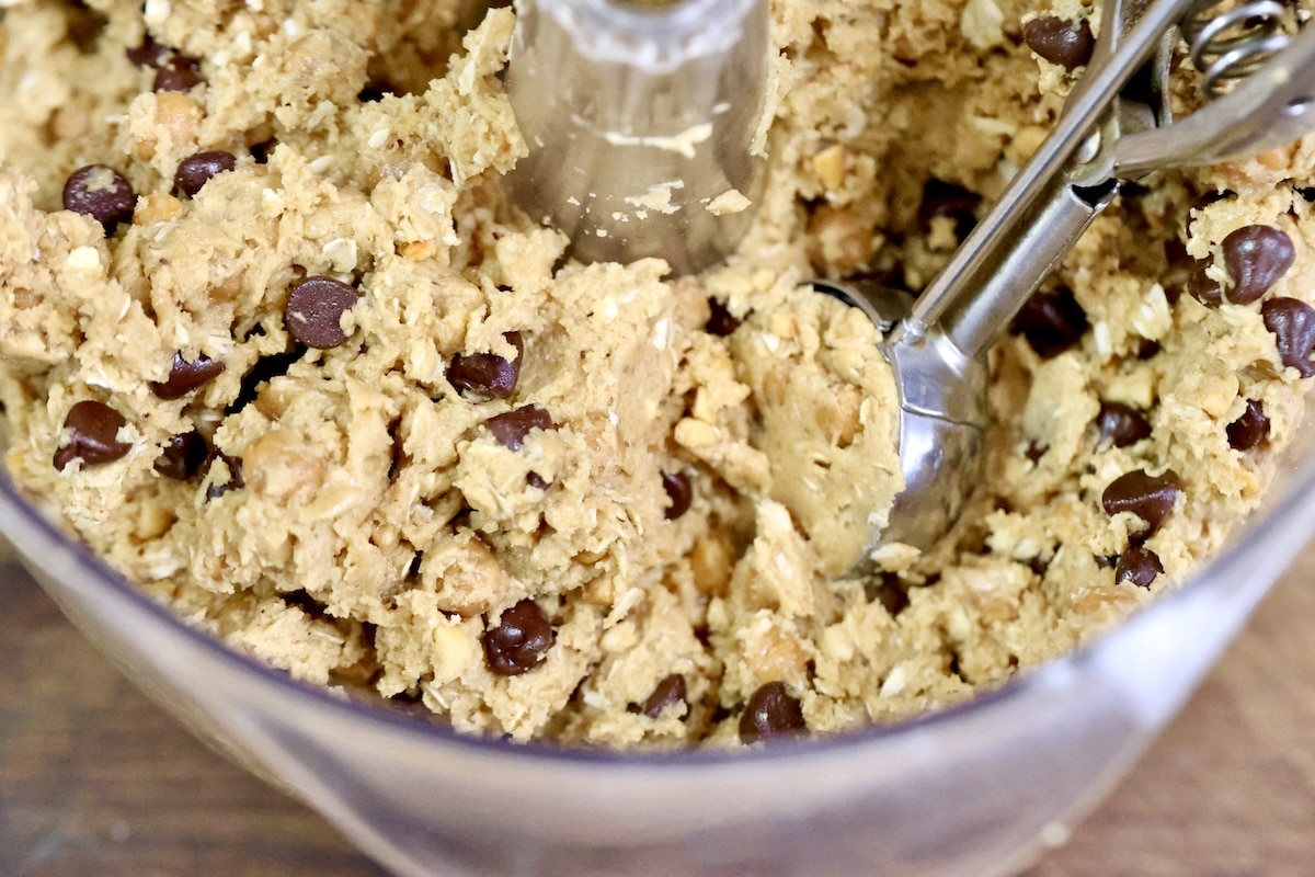 Cookie scoop full of chocolate chip peanut butter oatmeal cookie dough.
