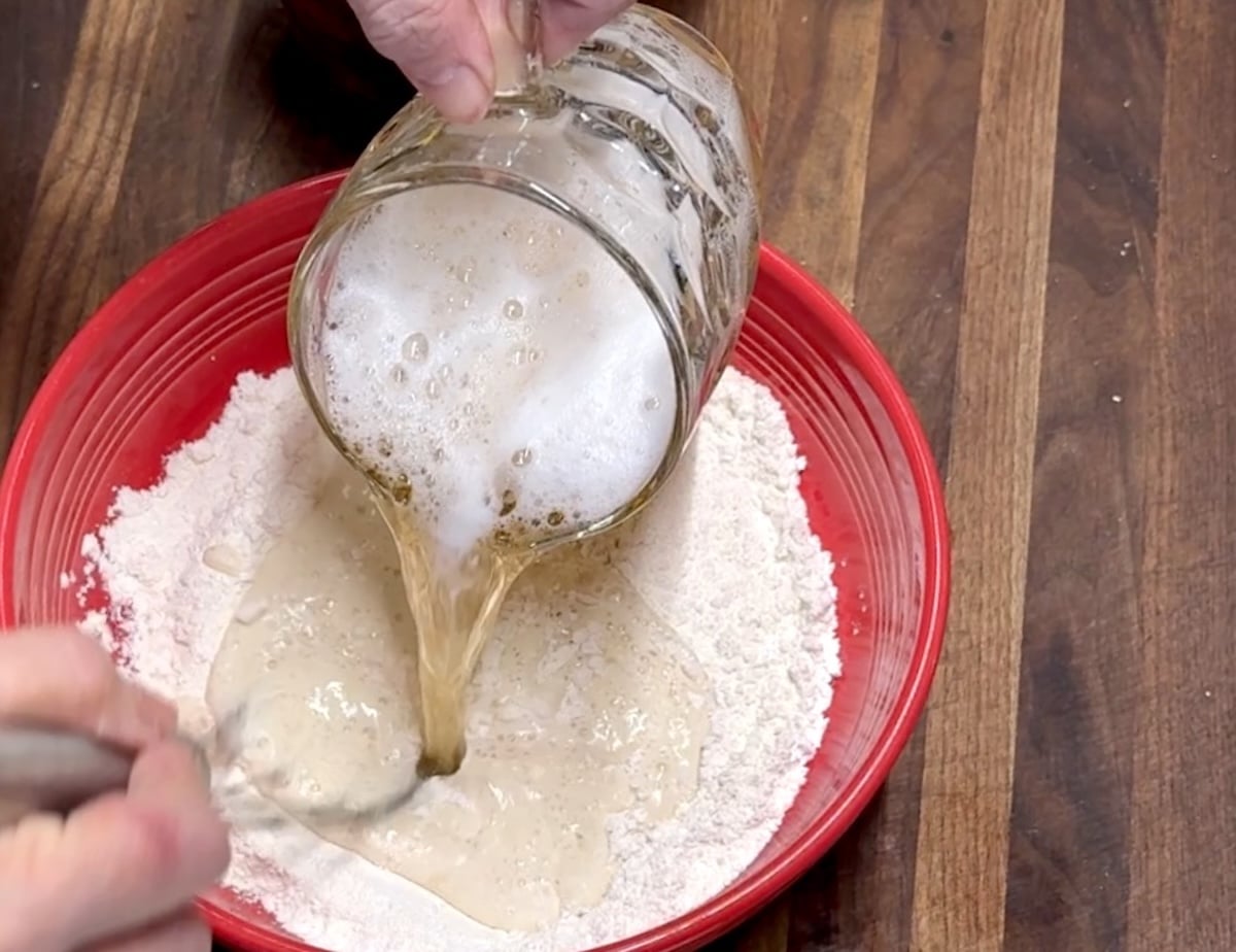 Pouring beer into flour for beer batter.