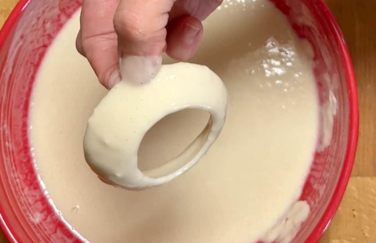 Battering onion rings.
