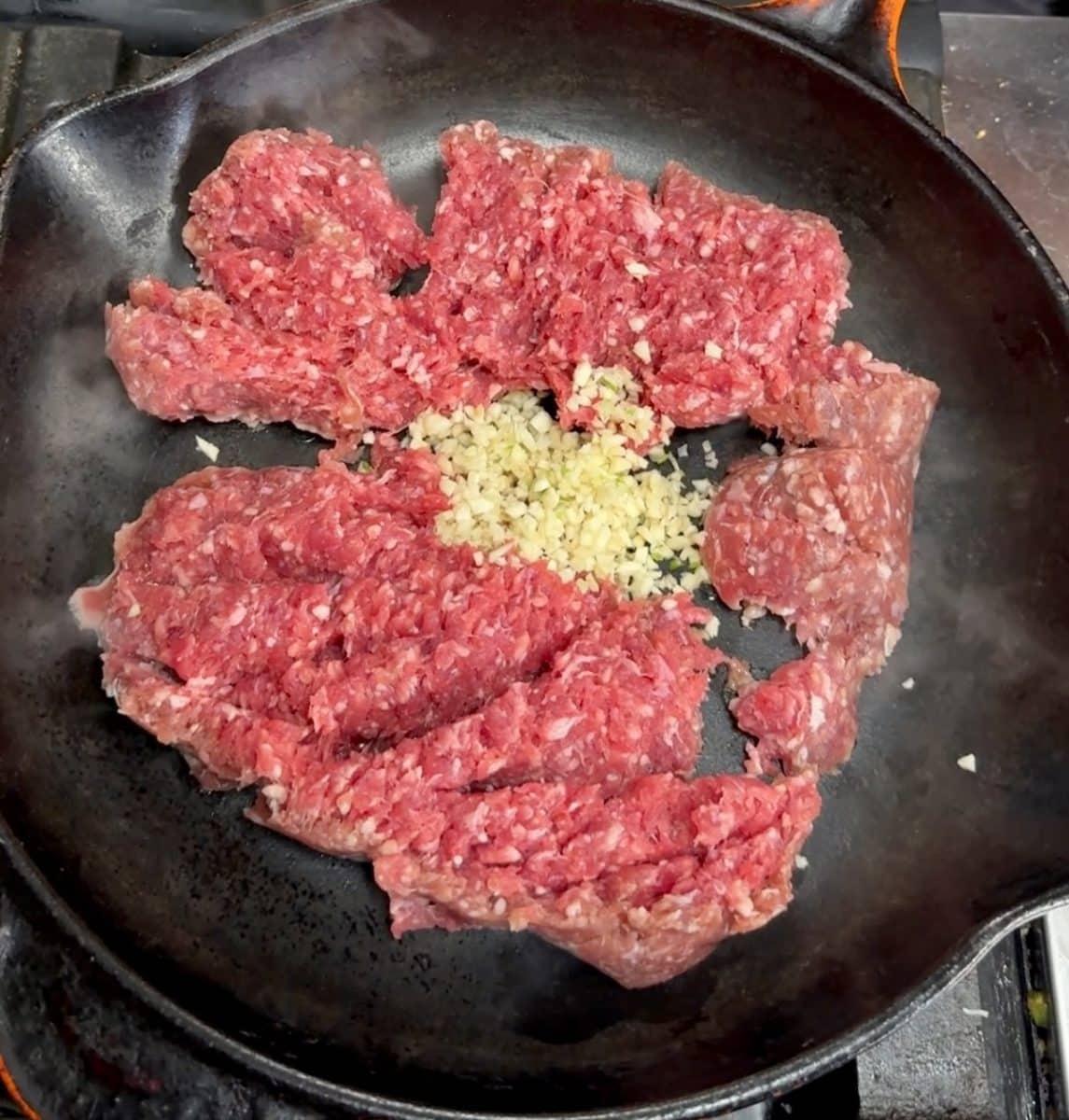 Cooking Ground beef with garlic in a pan.