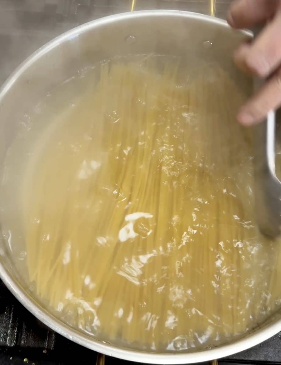 Boiling spaghetti.