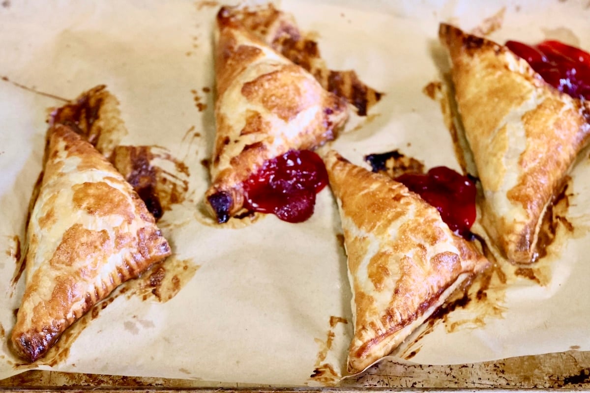Baked puff pastry turnovers o a baking sheet.