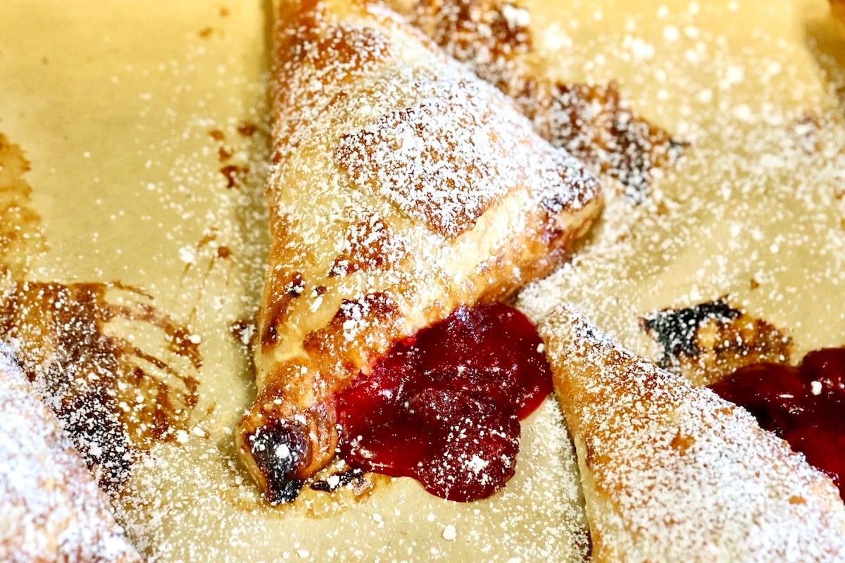 Strawberry turnover dusted with powdered sugar.