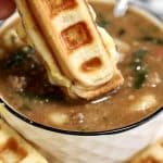 Waffle grilled cheese dipping into soup.