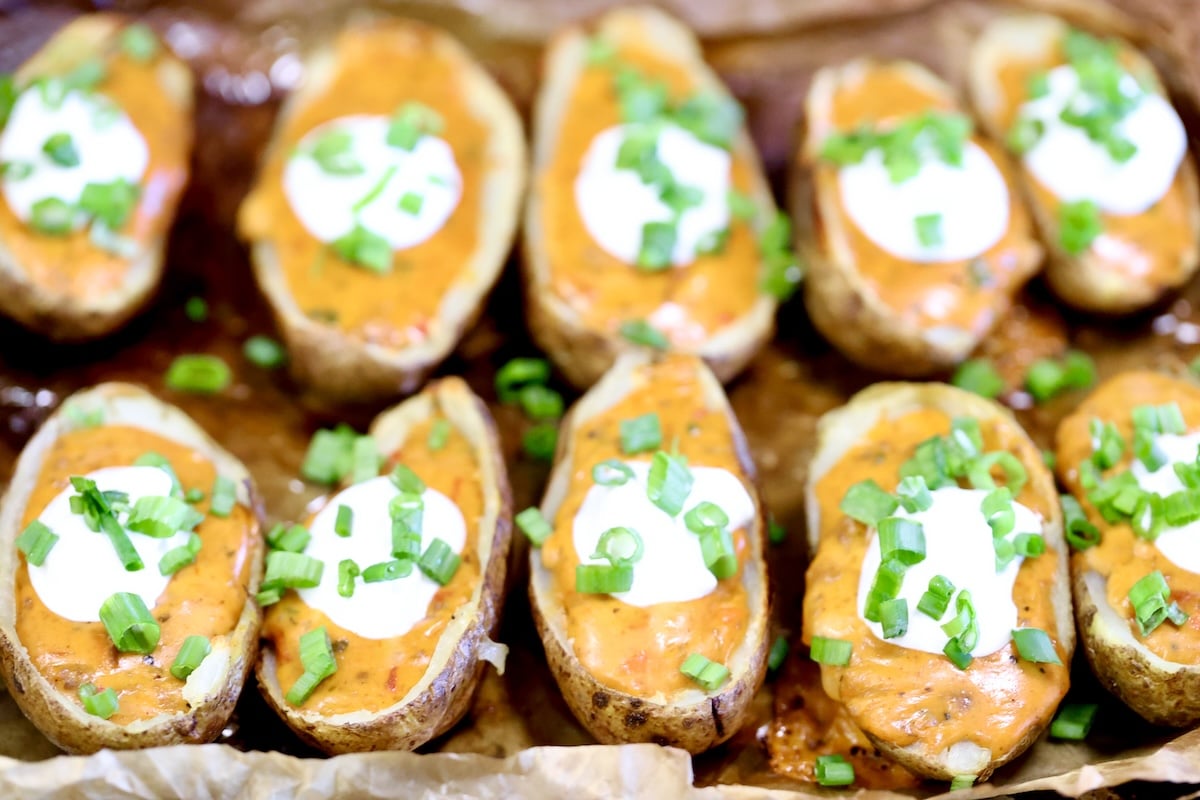 Chili cheese tater skins with sour cream and green onions.